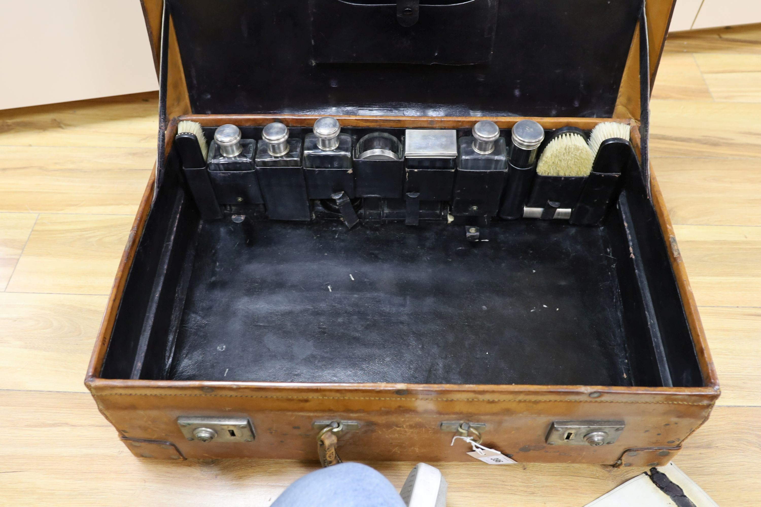 A Dupont travel suitcase, initialled ‘L.C.’ with French white metal mounted bottles